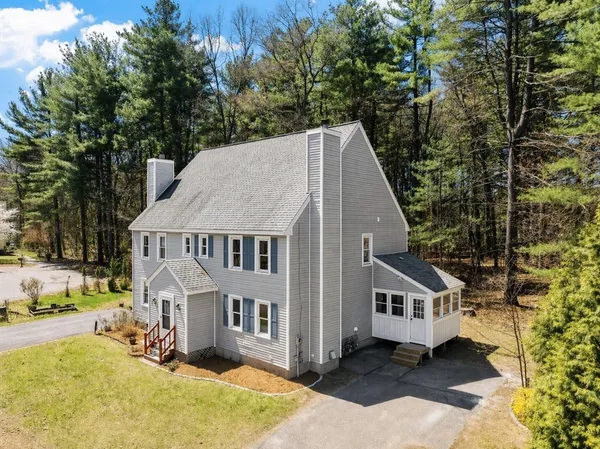an aerial view of a house with a yard patio and backyard