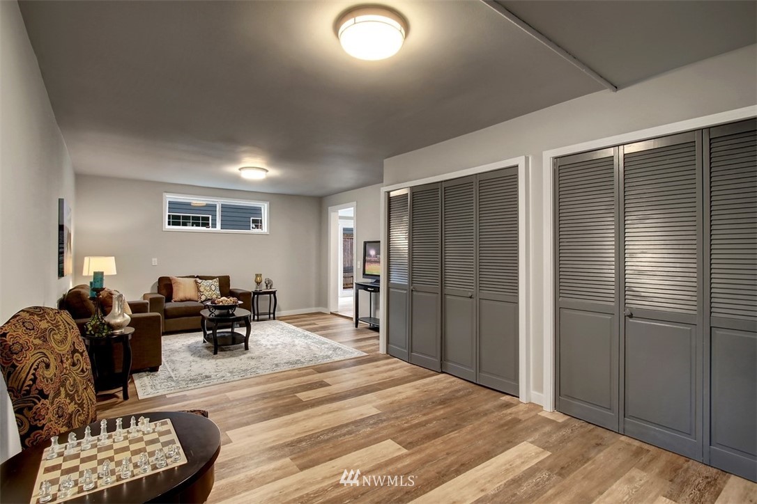 4401 Northeast 10th Street Renton, WA 98059 - Photo 11 of 18 a bedroom with furniture and a wooden floor