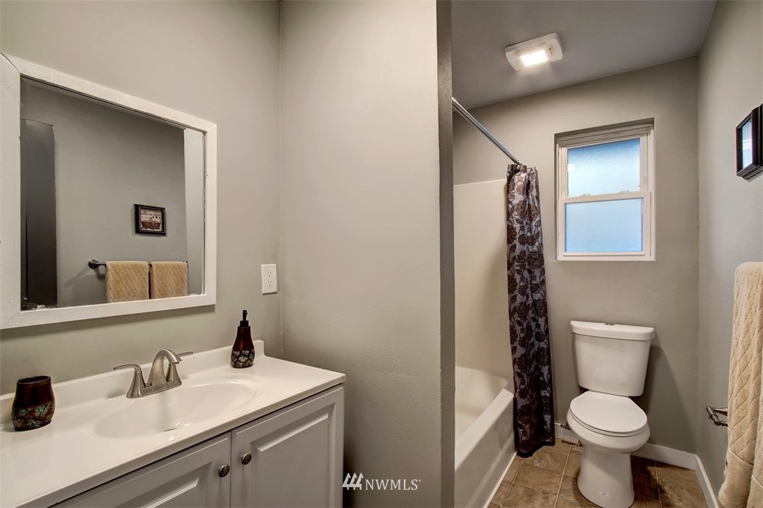 4401 Northeast 10th Street Renton, WA 98059 - Photo 12 of 18 a bathroom with a toilet sink and mirror