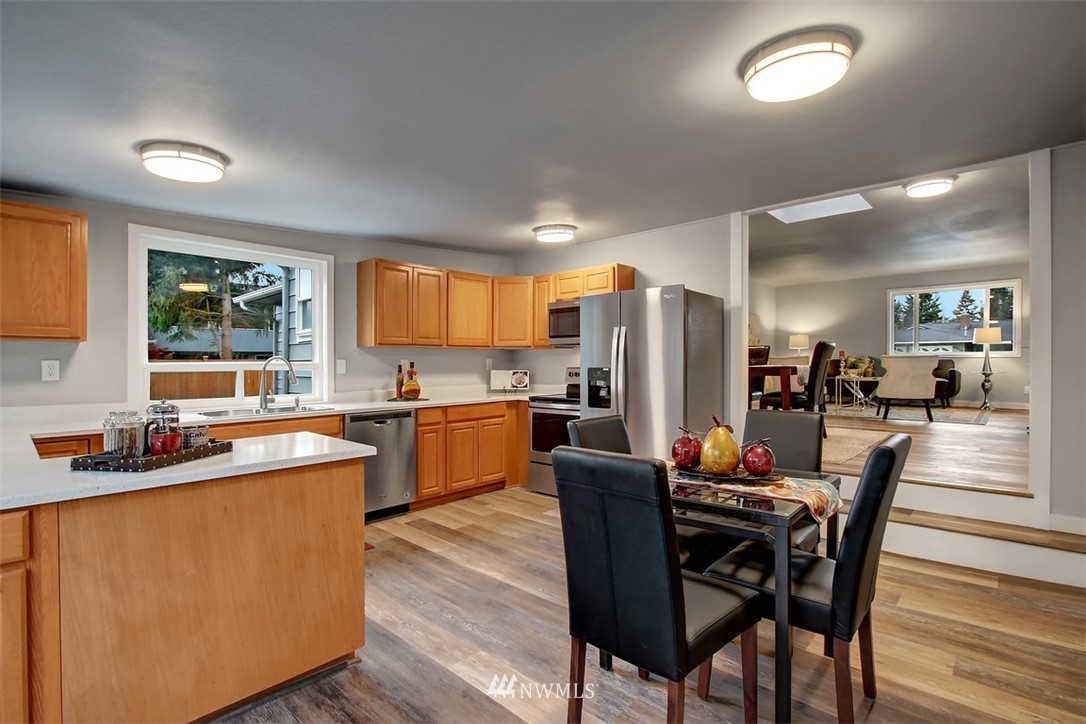 4401 Northeast 10th Street Renton, WA 98059 - Photo 5 of 18 a dining hall with stainless steel appliances granite countertop a dining table and chairs