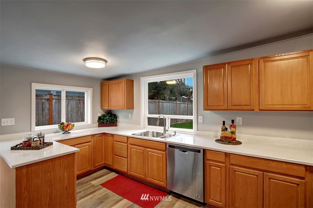 4401 Northeast 10th Street Renton, WA 98059 - Photo 7 of 18 a kitchen with a sink stove and cabinets