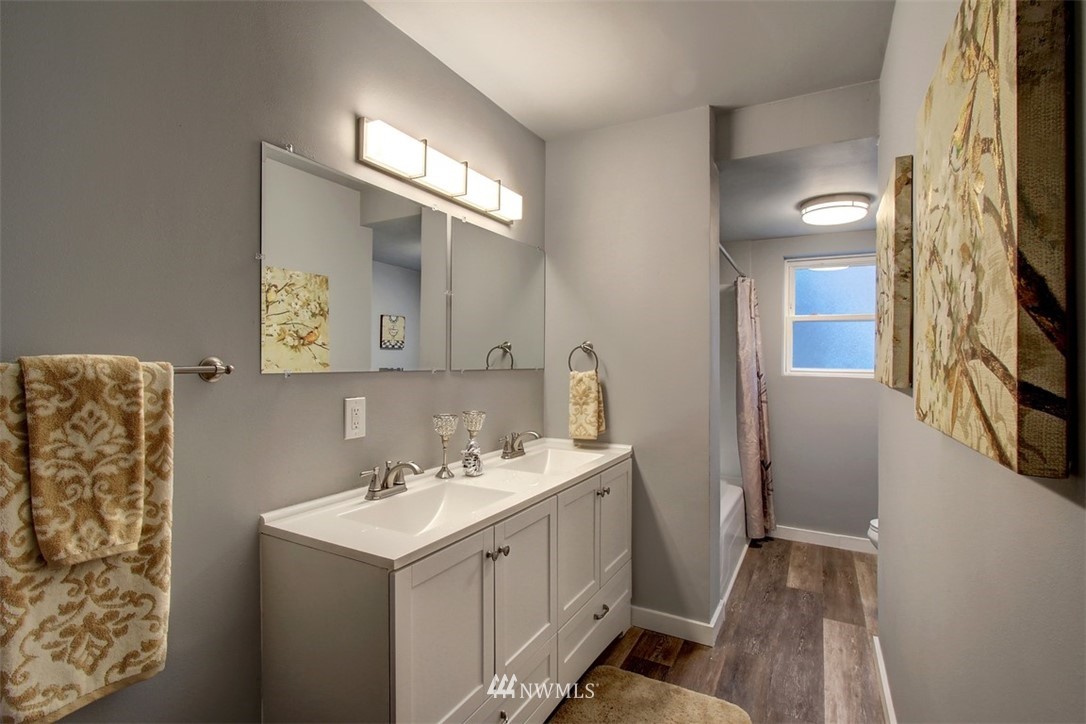 4401 Northeast 10th Street Renton, WA 98059 - Photo 9 of 18 a bathroom with a sink a toilet and a mirror