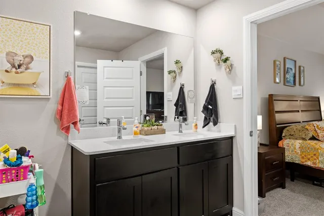 a bathroom with a sink vanity and a mirror