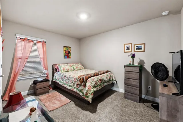 a bedroom with a bed and dresser