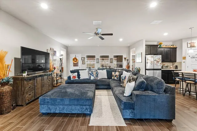 a living room with furniture and a flat screen tv