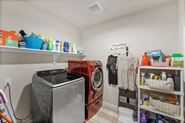 a utility room with sink dryer and washer