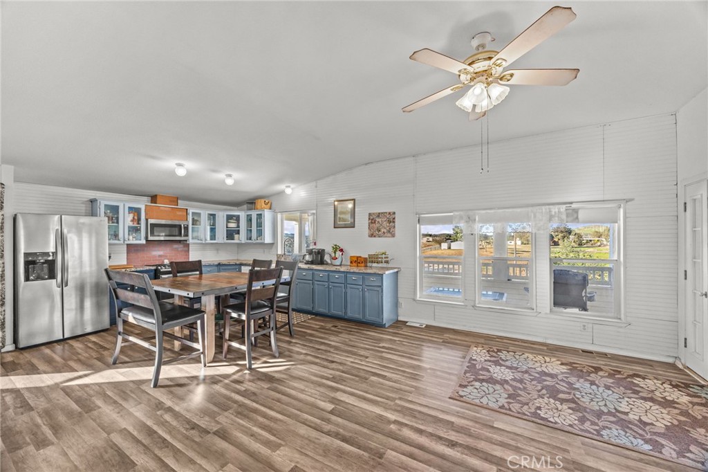 29825 Porth Road Murrieta, CA 92563 - Photo 13 of 40 a view of a dining room with furniture a rug and wooden floor