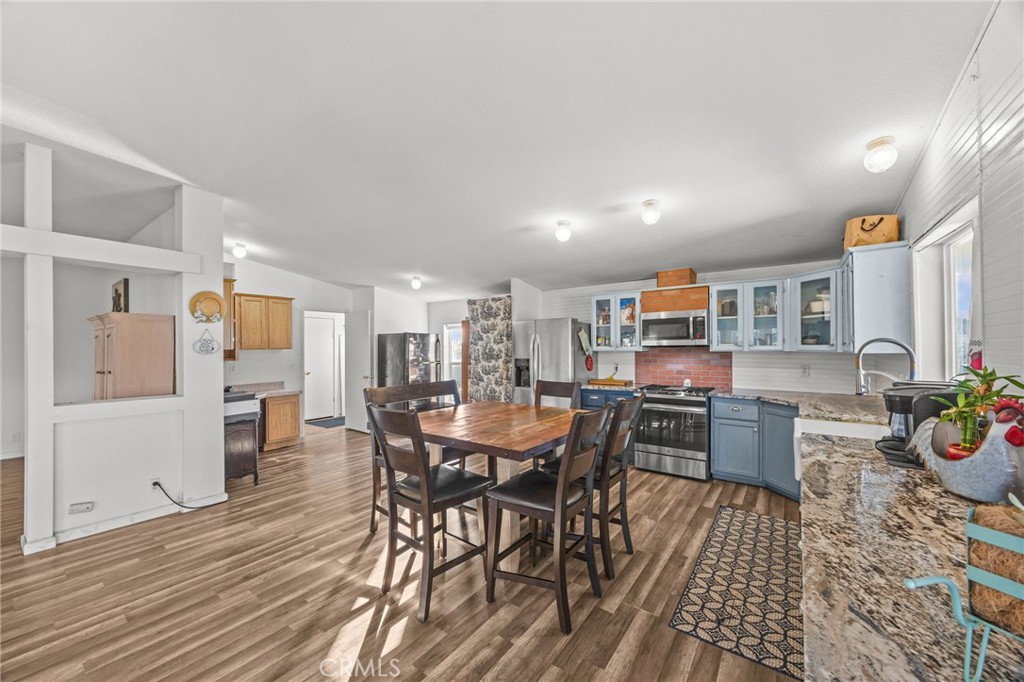 29825 Porth Road Murrieta, CA 92563 - Photo 18 of 40 a view of a dining room with furniture and wooden floor
