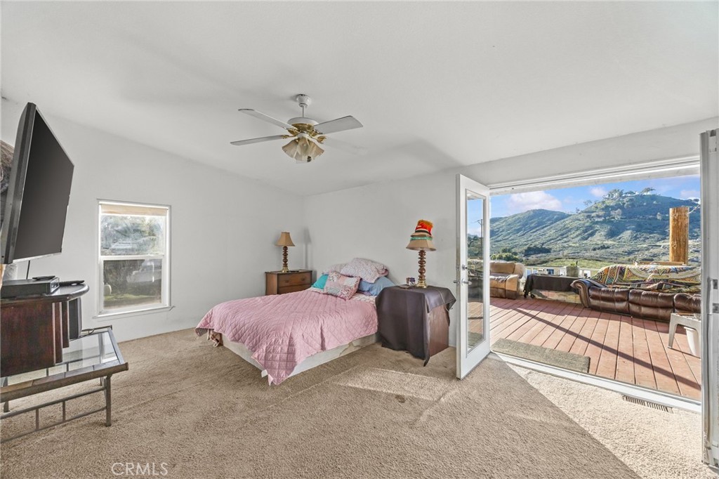 29825 Porth Road Murrieta, CA 92563 - Photo 22 of 40 a bedroom with a bed and a flat tv screen on dresser