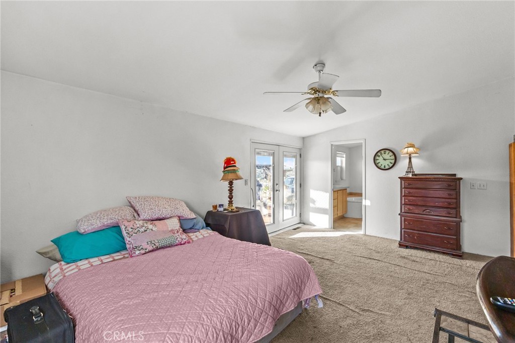 29825 Porth Road Murrieta, CA 92563 - Photo 25 of 40 a bedroom with a bed and a chandelier