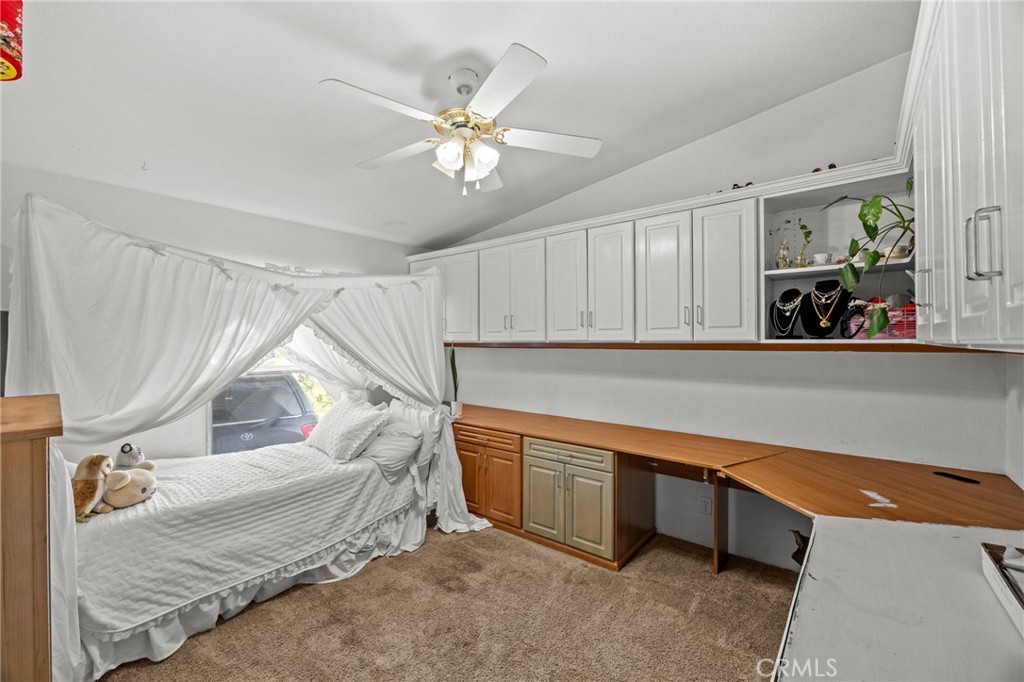 29825 Porth Road Murrieta, CA 92563 - Photo 29 of 40 a living room with a bed and a chandelier