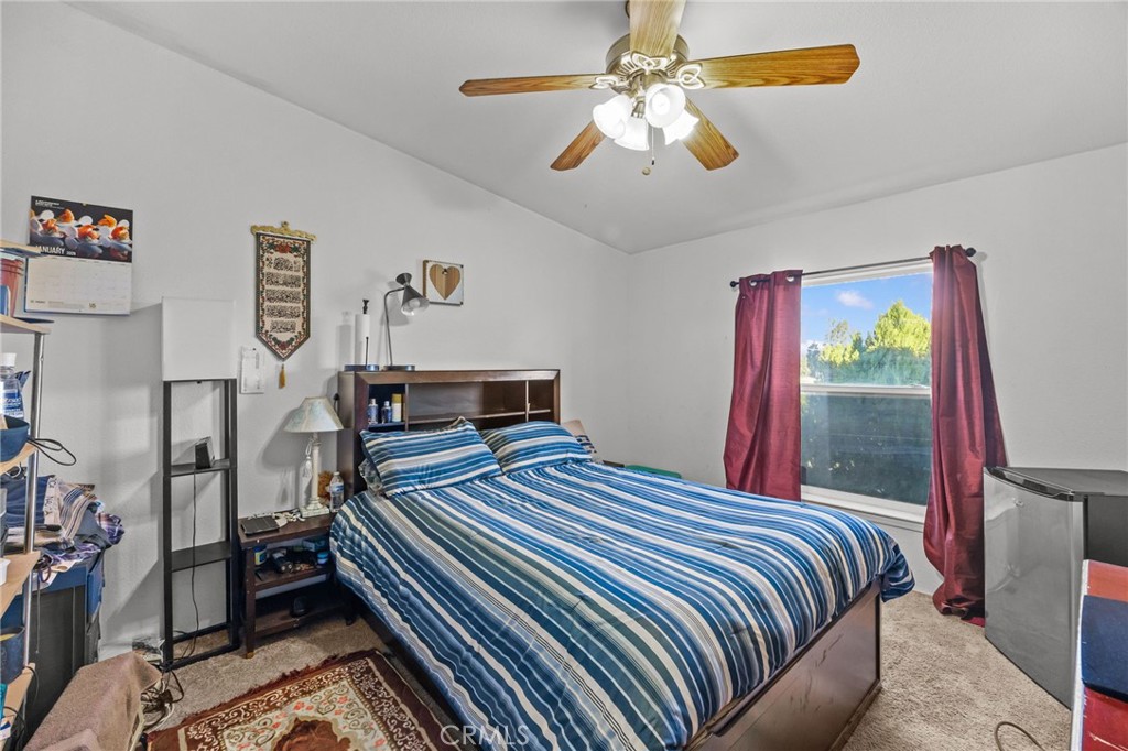 29825 Porth Road Murrieta, CA 92563 - Photo 32 of 40 a bedroom with a bed and a chandelier