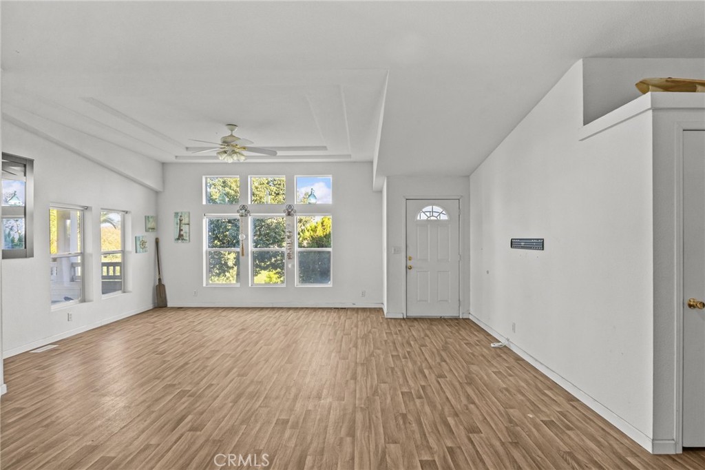 29825 Porth Road Murrieta, CA 92563 - Photo 9 of 40 a view of an empty room with wooden floor and a window