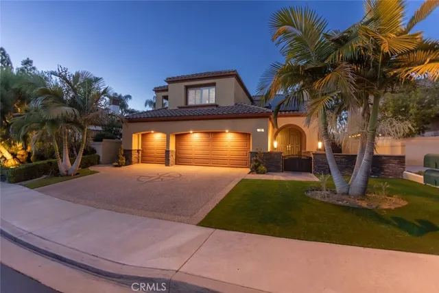 a front view of a house with a yard and a garage