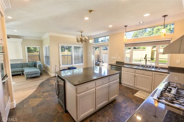 a kitchen with sink stove and cabinets
