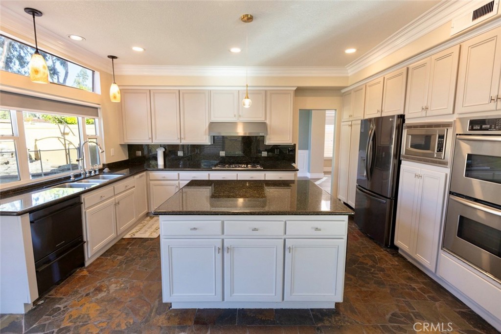 2605 Augusta Tustin, CA 92782 - Photo 13 of 44 a kitchen with a refrigerator sink and cabinets
