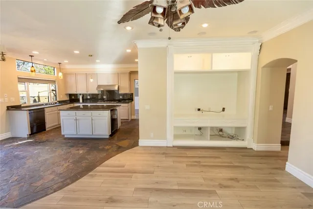 a view of a kitchen with stainless steel appliances granite countertop a stove and a sink