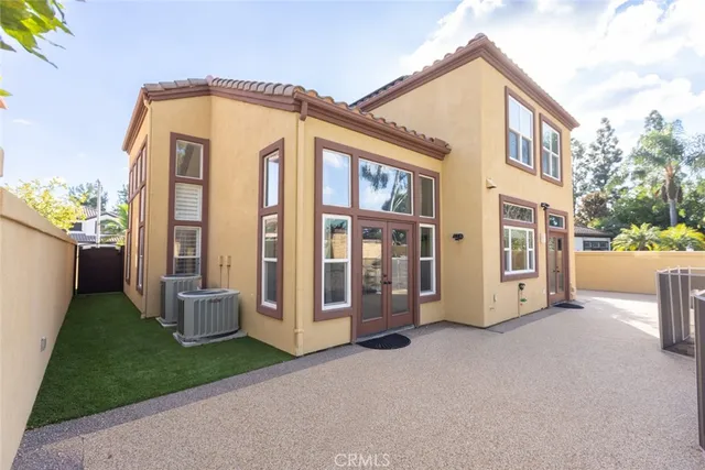 a view of a house with many windows and yard