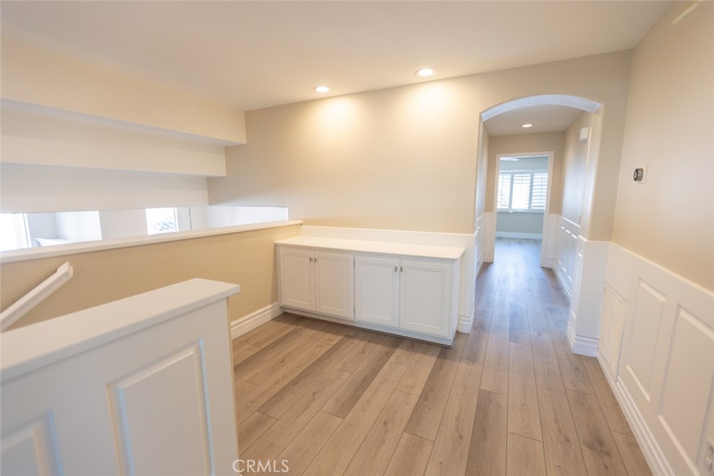 2605 Augusta Tustin, CA 92782 - Photo 26 of 44 a view of a hallway with wooden floor and staircase