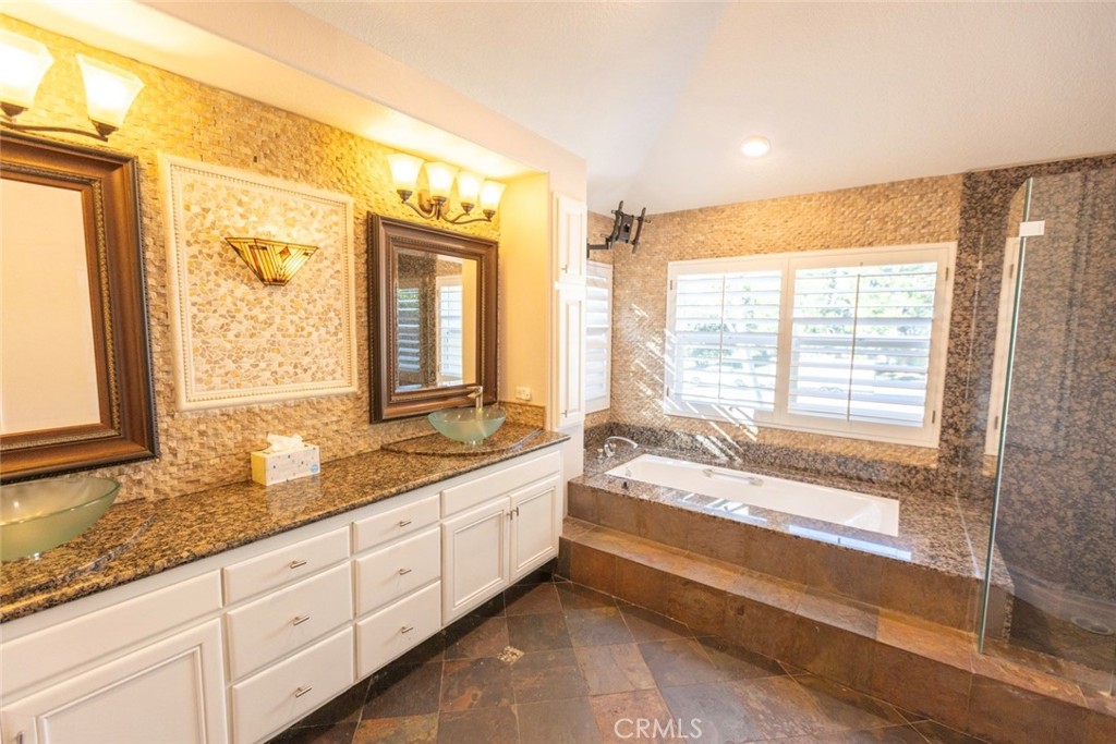 2605 Augusta Tustin, CA 92782 - Photo 31 of 44 a bathroom with a granite countertop tub and a large window