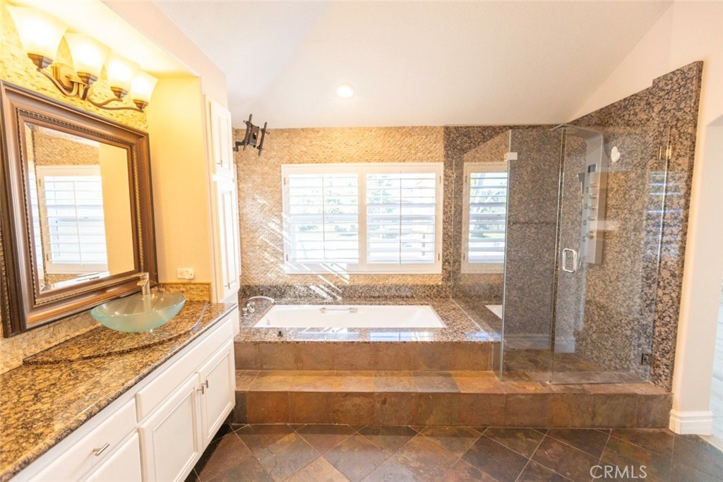2605 Augusta Tustin, CA 92782 - Photo 31 of 44 a spacious bathroom with a granite countertop tub and a sink