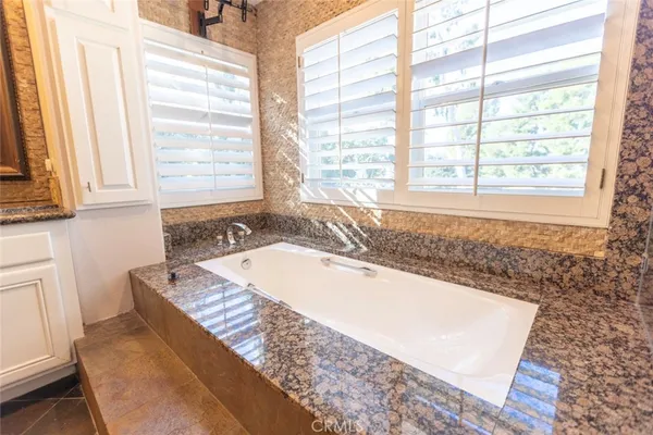 a bath tub sitting in a bathroom next to a window