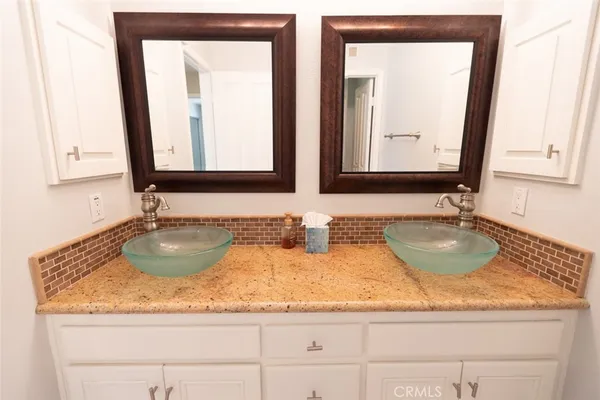a bathroom with sink granite and a mirror