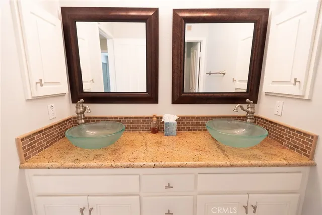 a bathroom with sink granite and a mirror