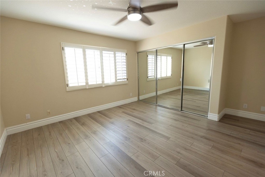 2605 Augusta Tustin, CA 92782 - Photo 37 of 44 an empty room with wooden floor fan and windows