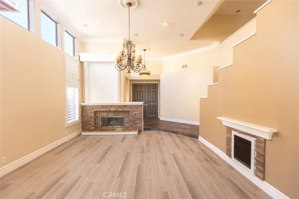 a view of main area fire place window and wooden floor