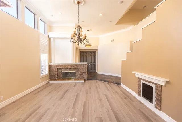 a view of main area fire place window and wooden floor