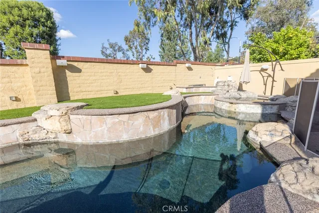 a view of a swimming pool with a patio
