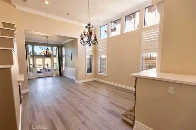 a view of a room with wooden floor and windows