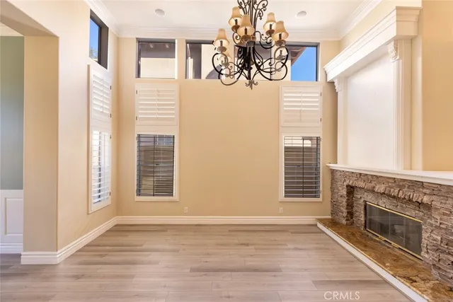 a view of an empty room with a fireplace and a window