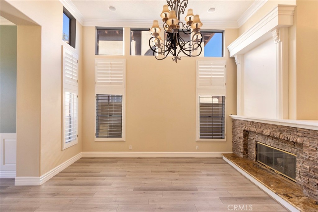 2605 Augusta Tustin, CA 92782 - Photo 7 of 44 a view of an empty room with a fireplace and a window