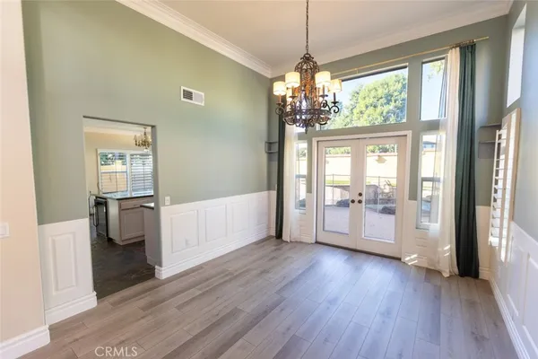 a view of a big room with wooden floor and windows