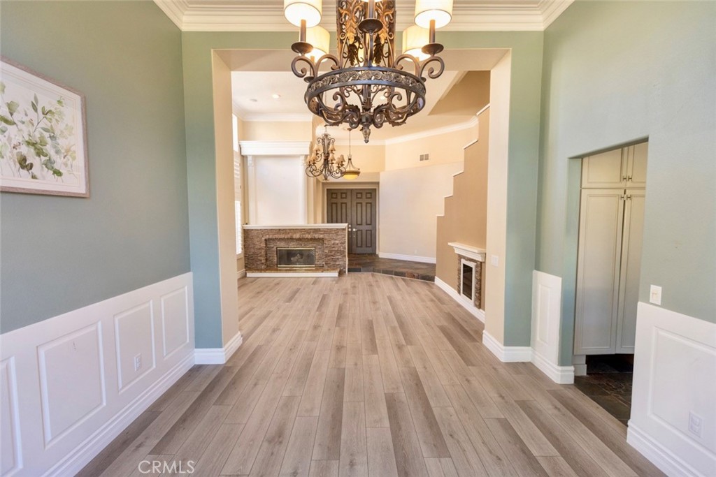 2605 Augusta Tustin, CA 92782 - Photo 10 of 44 a view of hallway with wooden floor and a chandelier