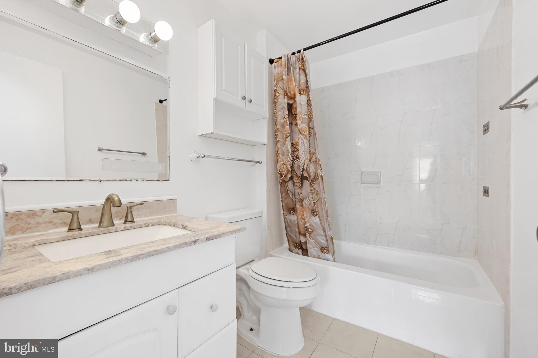 9640 Homestead Court, Unit F Laurel, MD 20723 - Photo 13 of 14 a bathroom with a granite countertop sink toilet and shower