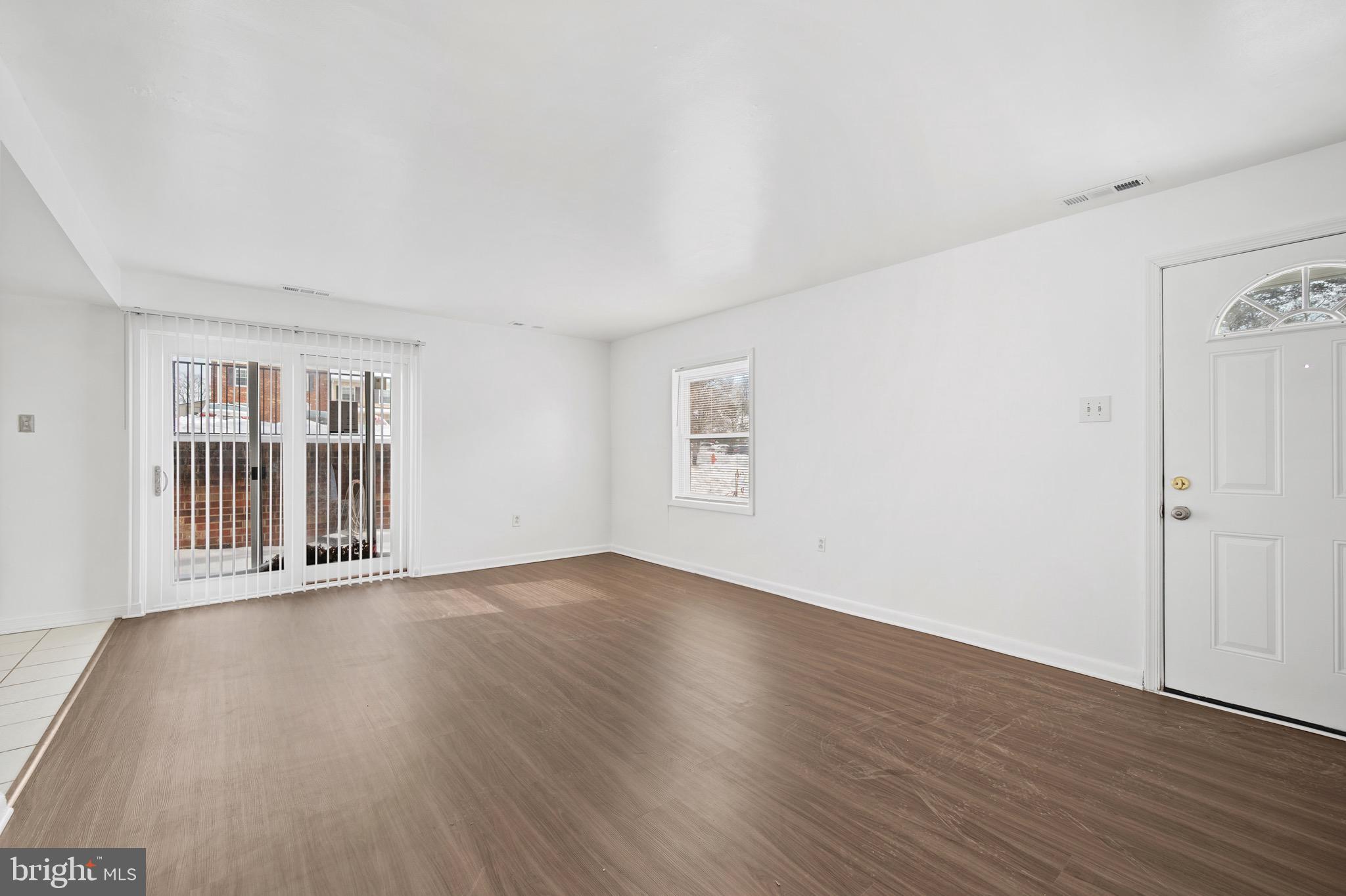 9640 Homestead Court, Unit F Laurel, MD 20723 - Photo 6 of 14 a view of an empty room with wooden floor and a window