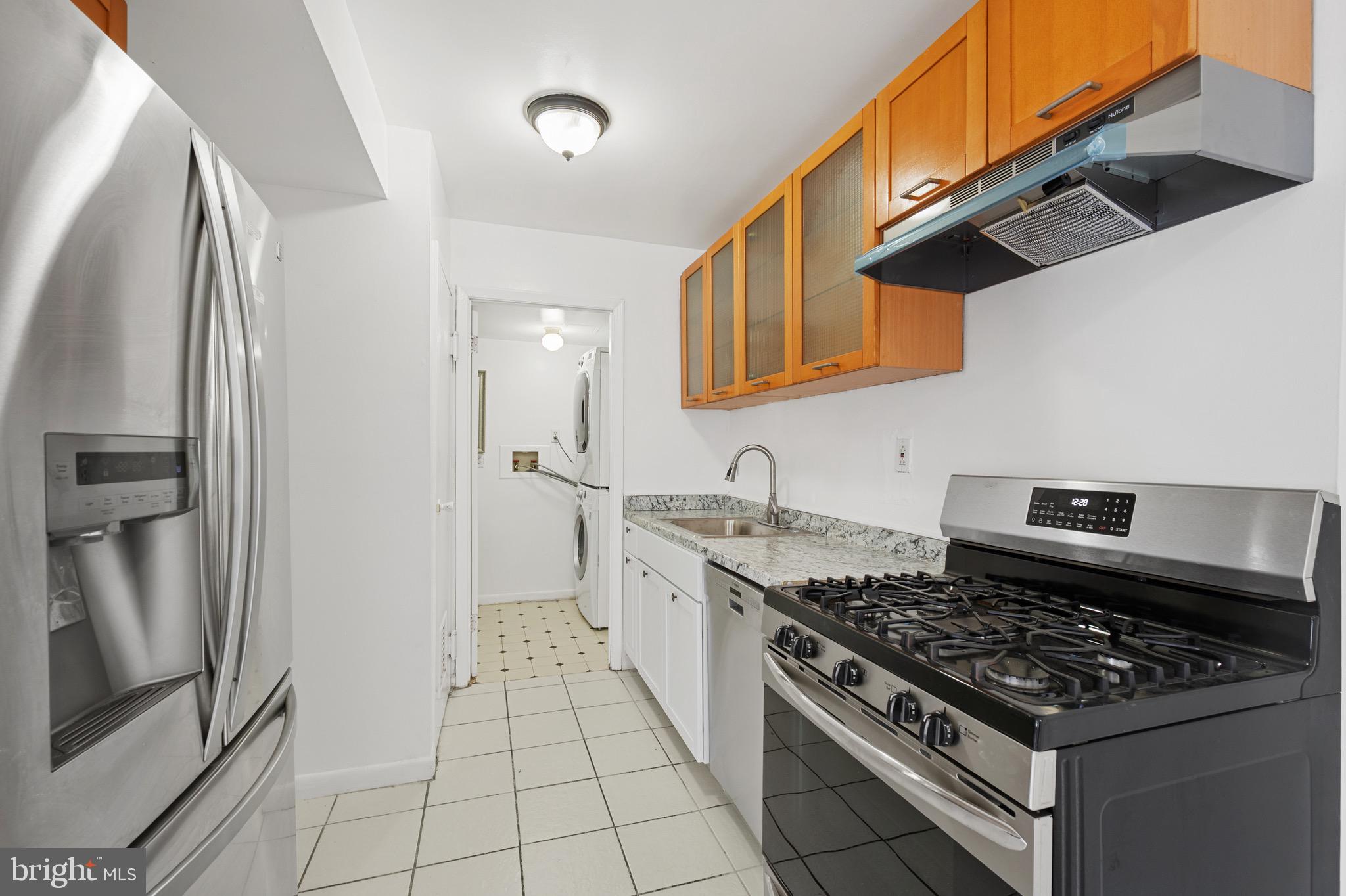 9640 Homestead Court, Unit F Laurel, MD 20723 - Photo 7 of 14 a kitchen with stainless steel appliances granite countertop a stove a refrigerator and a sink