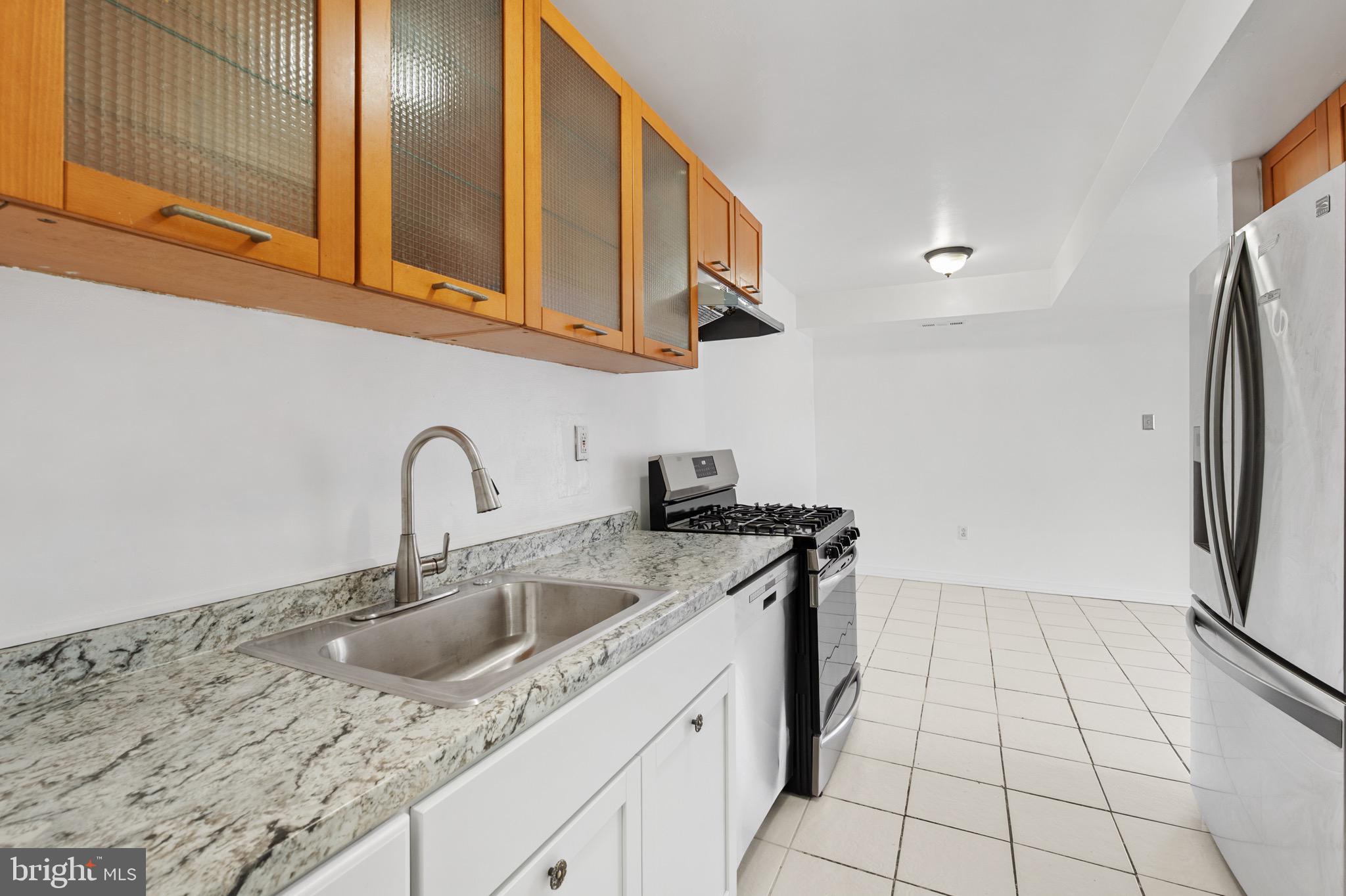 9640 Homestead Court, Unit F Laurel, MD 20723 - Photo 8 of 14 a kitchen with stainless steel appliances granite countertop a sink stove and cabinets