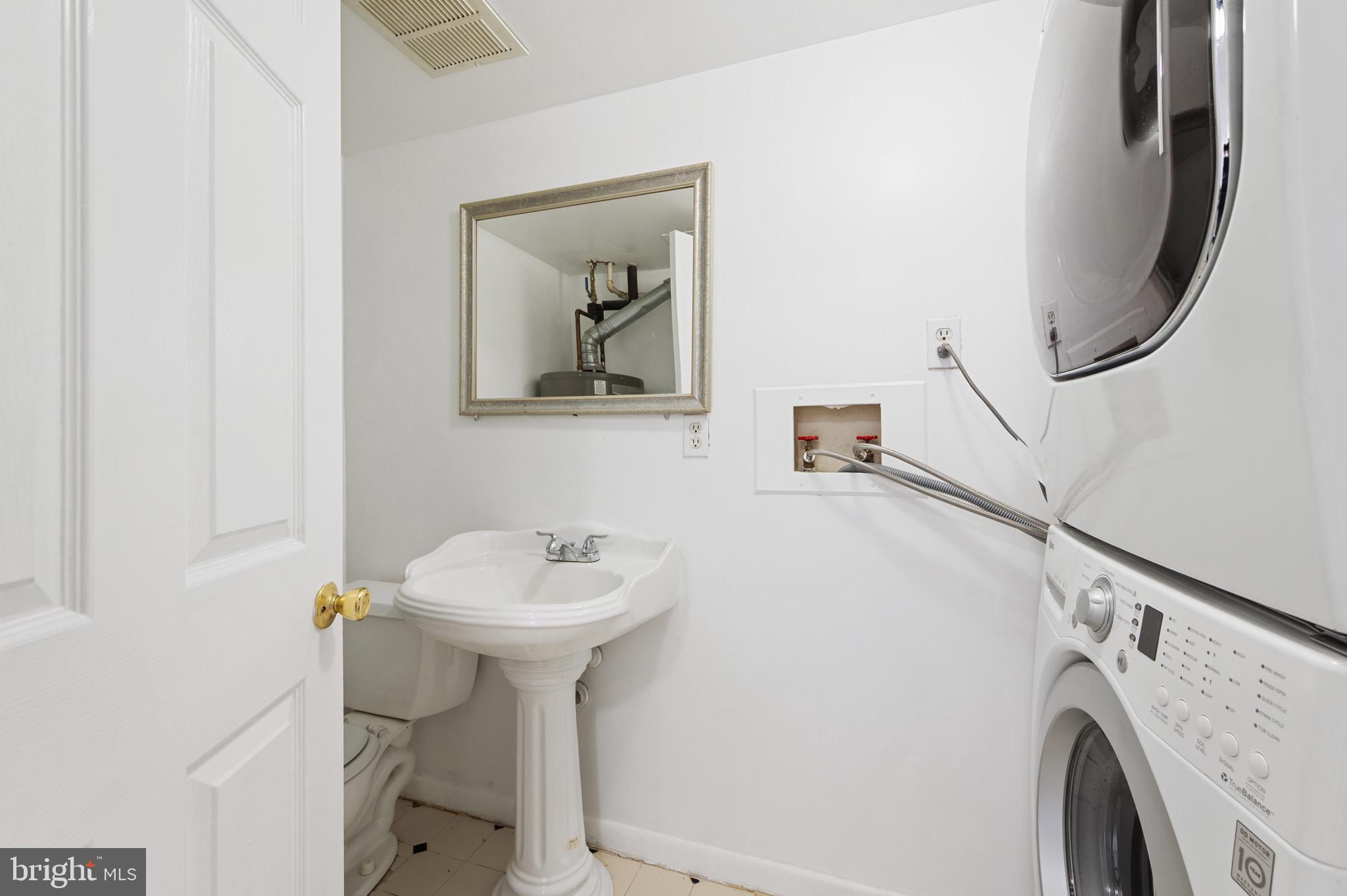 9640 Homestead Court, Unit F Laurel, MD 20723 - Photo 10 of 14 a bathroom with a sink toilet and a mirror