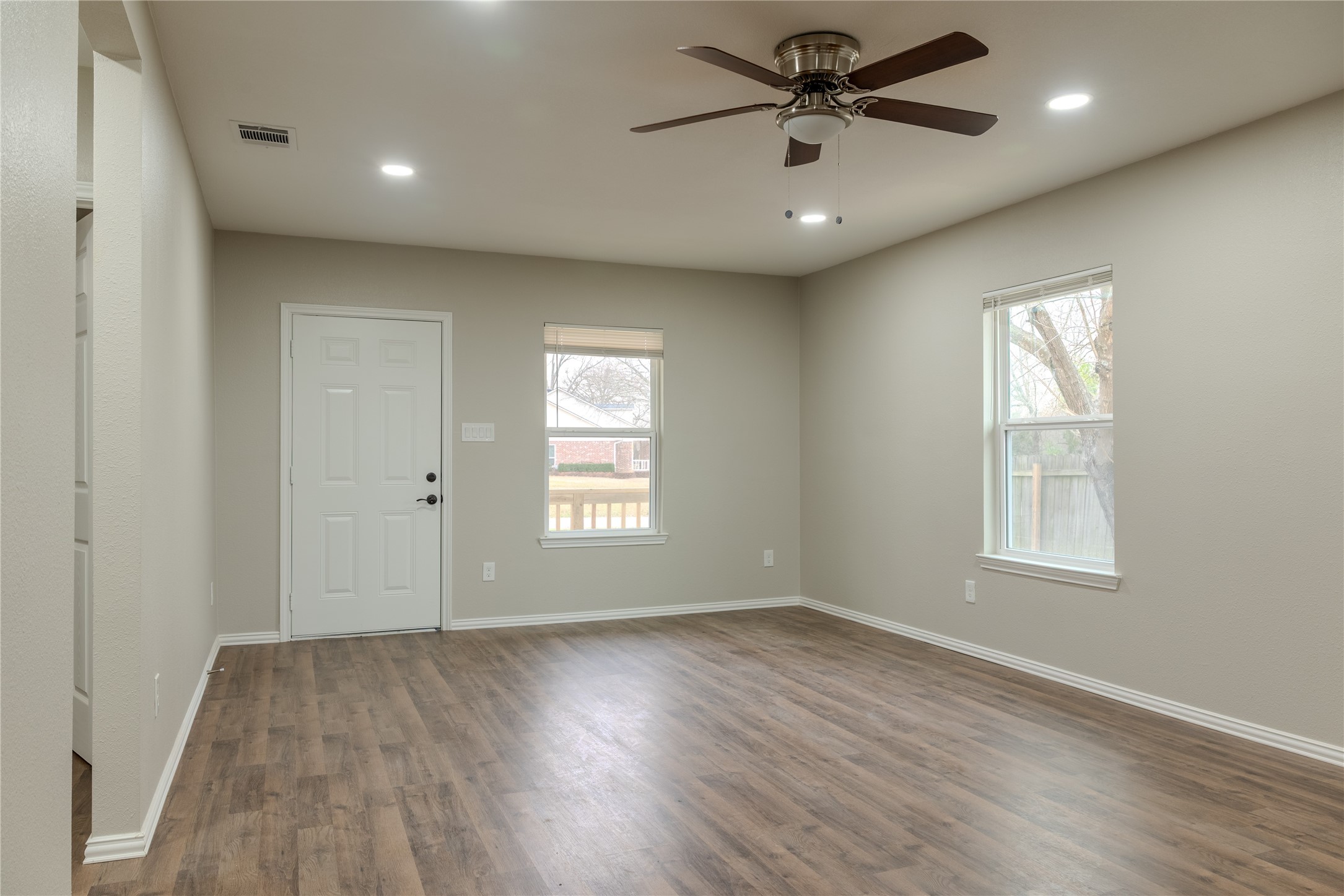 729 Planters Street Emory, TX 75440 - Photo 6 of 22 a view of an empty room with a window and wooden floor