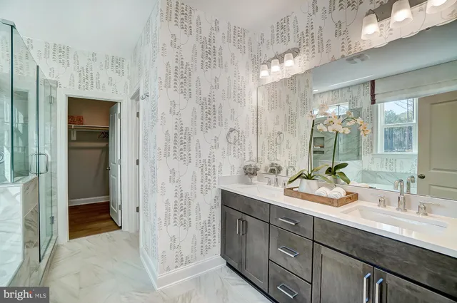 a bathroom with a tub a sink and a shower