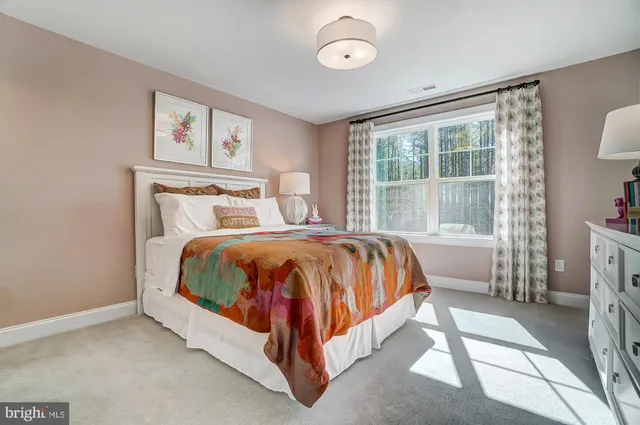 a bedroom with a bed and painting on the wall