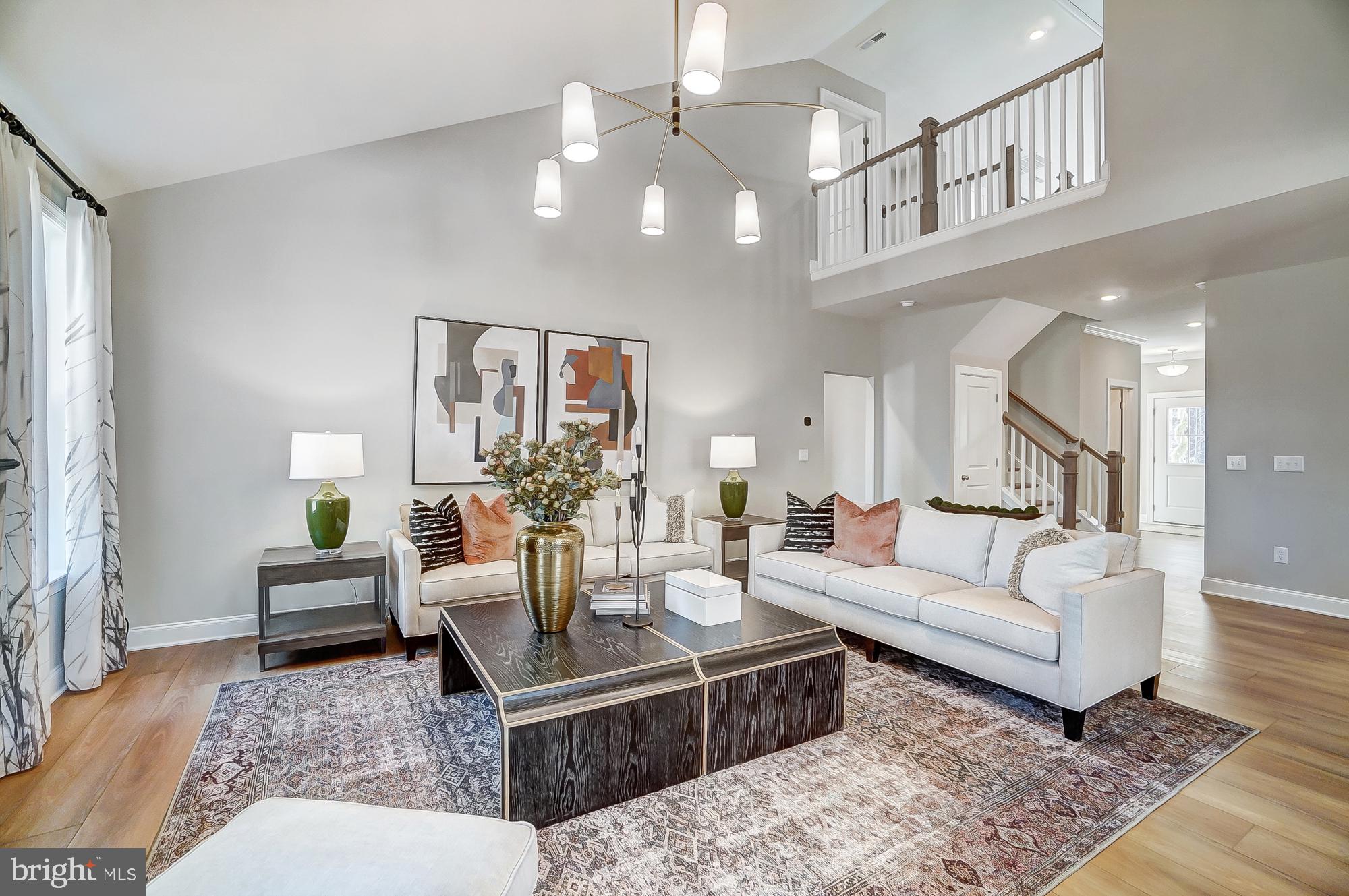14925 Abelia Court Issue, MD 20645 - Photo 6 of 42 a living room with furniture and a chandelier