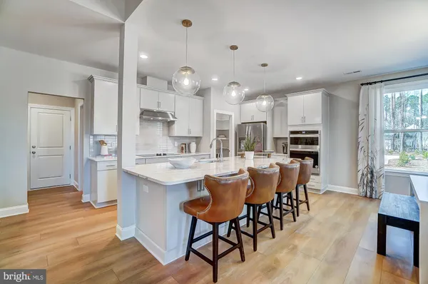 a large kitchen with a table and chairs