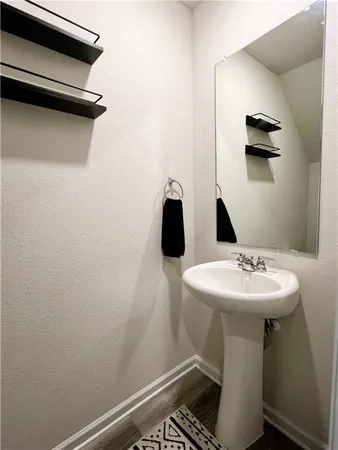 a bathroom with a granite countertop sink a toilet and a mirror