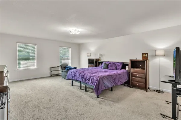 a bed sitting in a bedroom next to a window