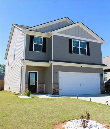 a front view of a house with garage
